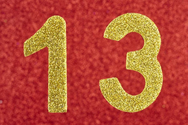 Number thirteen golden color over a red background. Anniversary. — Stock Photo, Image