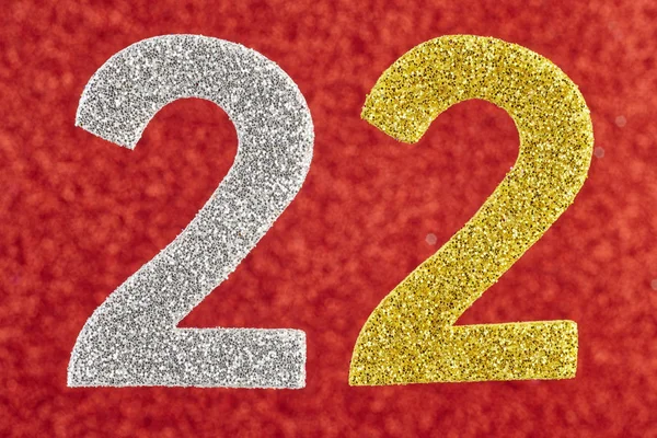 Αριθμός είκοσι δύο ασημένια χρυσό πάνω σε κόκκινο φόντο. Επέτειος — Φωτογραφία Αρχείου