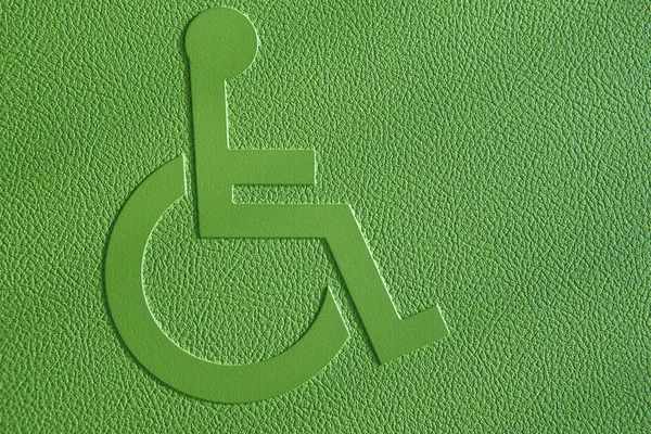 Disabled symbol on a green textured background. — Stock Photo, Image