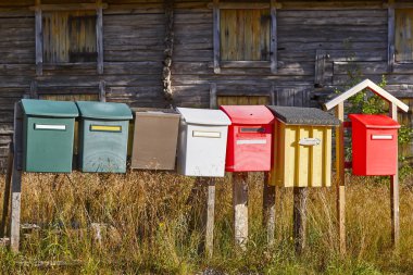 Traditional colorful vintage mailboxes in the countryside clipart