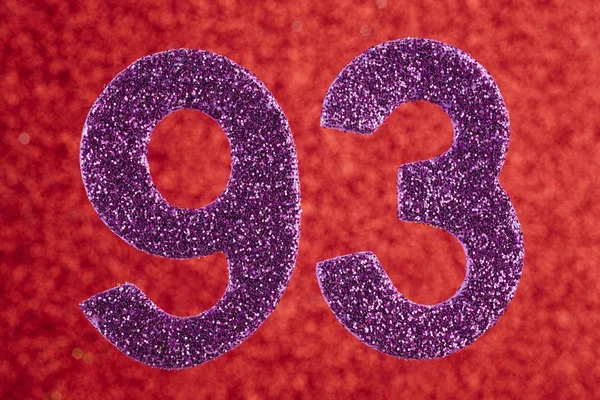 Номер дев'яносто три фіолетового кольору на червоному тлі. Ювілеї — стокове фото