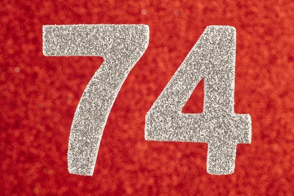 Number seventy-four silver color over a red background. Annivers — Stock Photo, Image