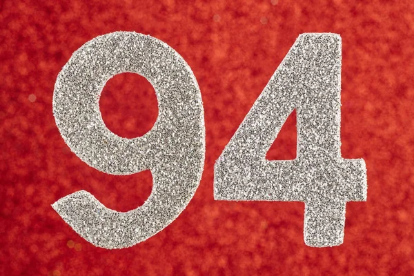 Número noventa e quatro cor de prata sobre um fundo vermelho. Anniversa — Fotografia de Stock