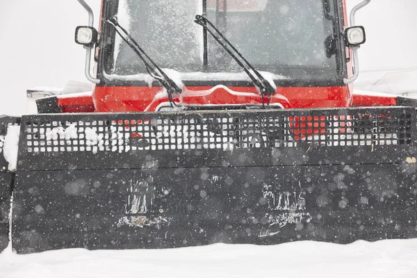 Snow blower truck covered by snow. Winter time. Snowing