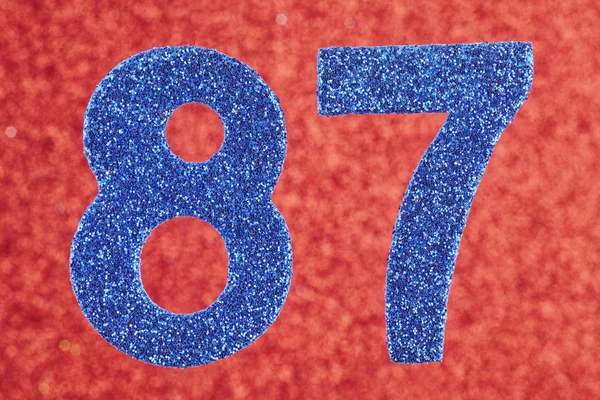 Numero ottantasette colore blu su uno sfondo rosso. Anniversario — Foto Stock