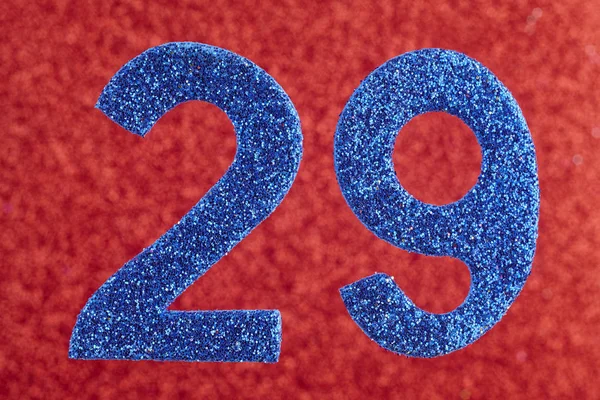 Numéro vingt-neuf couleur bleue sur un fond rouge. Anniversaire — Photo