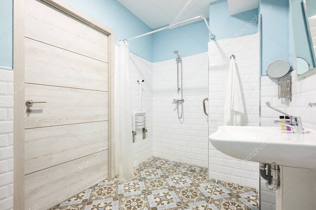 Decorated bathroom adapted for disabled people. Contemporany accessibility indoor architecture