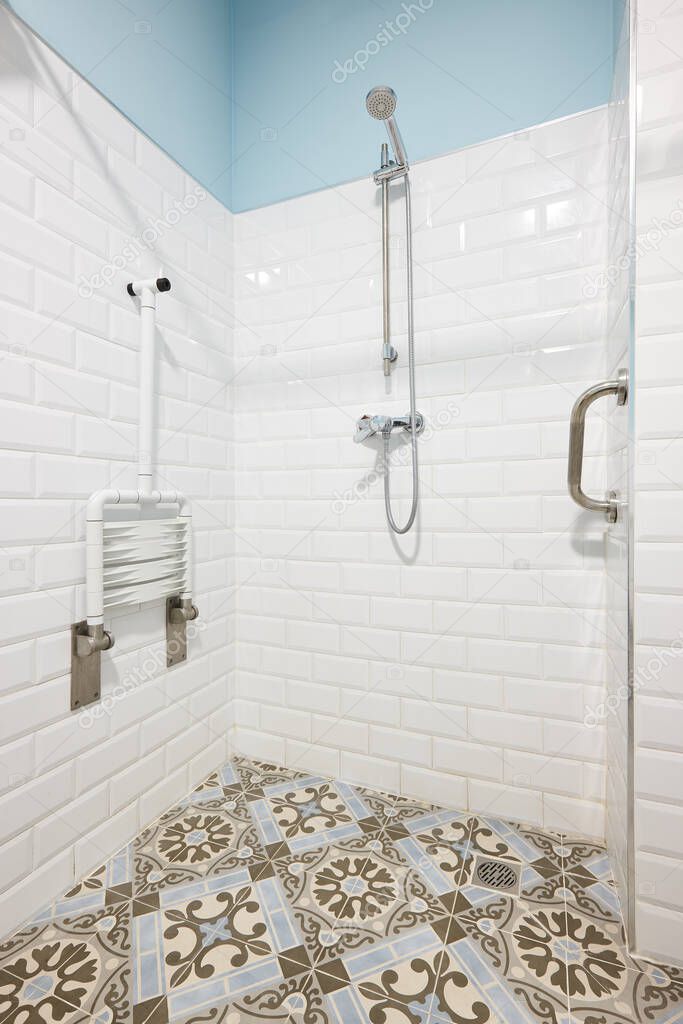 Moderm shower for disabled people in white and blue tone