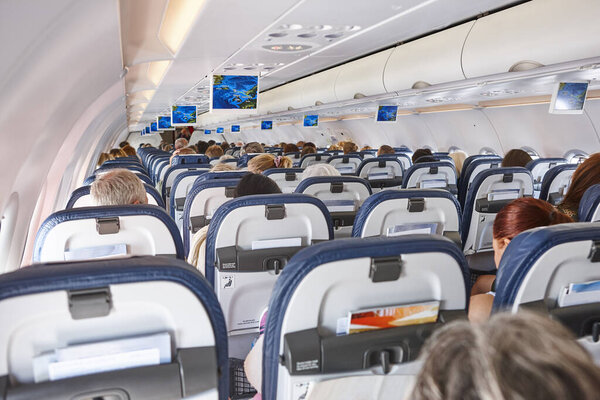 Airplane interior with seats and display with gps. Comercial flight