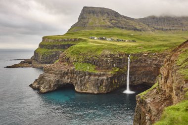 Vagar'da şelale ve kayalıklar. Faroe Adaları dramatik sahil şeridi. Gasaladur