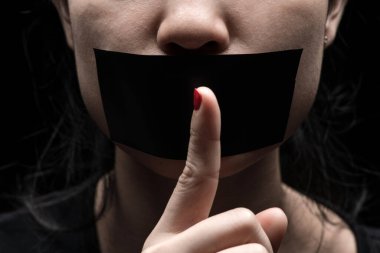 Concept on the topic of freedom of speech, censorship, freedom of press. International Human Right day: the girl's face is sealed her mouth with black paper clipart