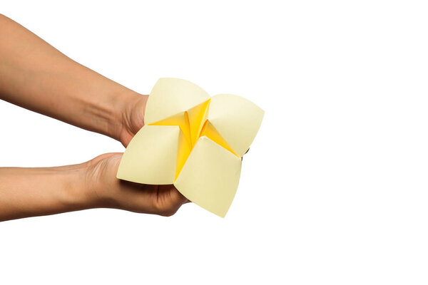 Close up of hand in a paper fortune teller isolated on white background.