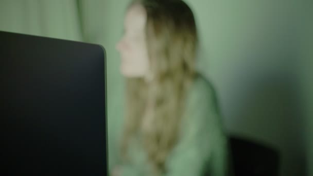 Una mujer trabaja desde casa. Una chica con el pelo largo se sienta frente a una pantalla brillante. Oficina central. Precauciones para la epidemia del virus. Color cambiando de fondo. Cuarentena por Coronavirus. Quédate en casa. . — Vídeos de Stock