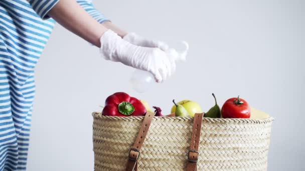 Disinfection. Precautions for the epidemic of the virus. Coronavirus quarantine. Woman in latex gloves wipe the handle of a basket of groceries with a disinfector. Safe shopping. Stay safe. — Stock Video