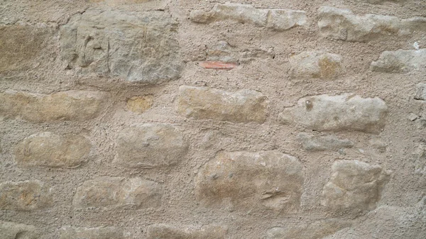 Textur der Natursteinmauer. Mittelalterliches Mauerwerk. Uralte Mauer. Steinmauer. Makrotextur. Mittelalterliche Architektur. Raues Mauerwerk. Hintergrundtextur. — Stockfoto