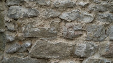 Doğal taş duvar dokusu. Ortaçağ duvarcılığı. Eski duvar. Taş duvar. Makro doku. Ortaçağ mimarisi. Zorlu duvarcılık. Arkaplan dokusu.
