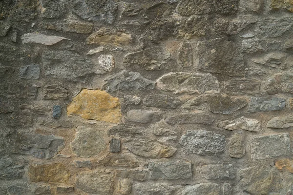 Természetes kőfal textúra. Középkori kőművesség. Ősi fal. Kőtéglafal. Makro textúra. Középkori építészet. Kemény falazat. Háttér-szerkezet. — Stock Fotó