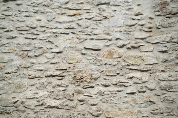 Természetes kőfal textúra. Középkori kőművesség. Ősi fal. Kőtéglafal. Makro textúra. Középkori építészet. Kemény falazat. Háttér-szerkezet. — Stock Fotó