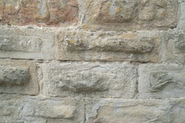 Склад природної кам'яної стіни. Середньовічна кладка. Древній мур. Кам'яна цегляна стіна. Макротекстура. Середньовічна архітектура. Жорсткий муляж. Фонова текстура. — стокове фото