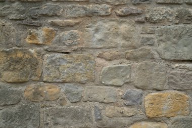Doğal taş duvar dokusu. Ortaçağ duvarcılığı. Eski duvar. Taş duvar. Makro doku. Ortaçağ mimarisi. Zorlu duvarcılık. Arkaplan dokusu.