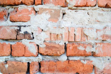 Background of stone wall texture. Masonry of red brick and cement.