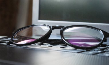 Desktop with a laptop. Safety glasses for working at a computer.