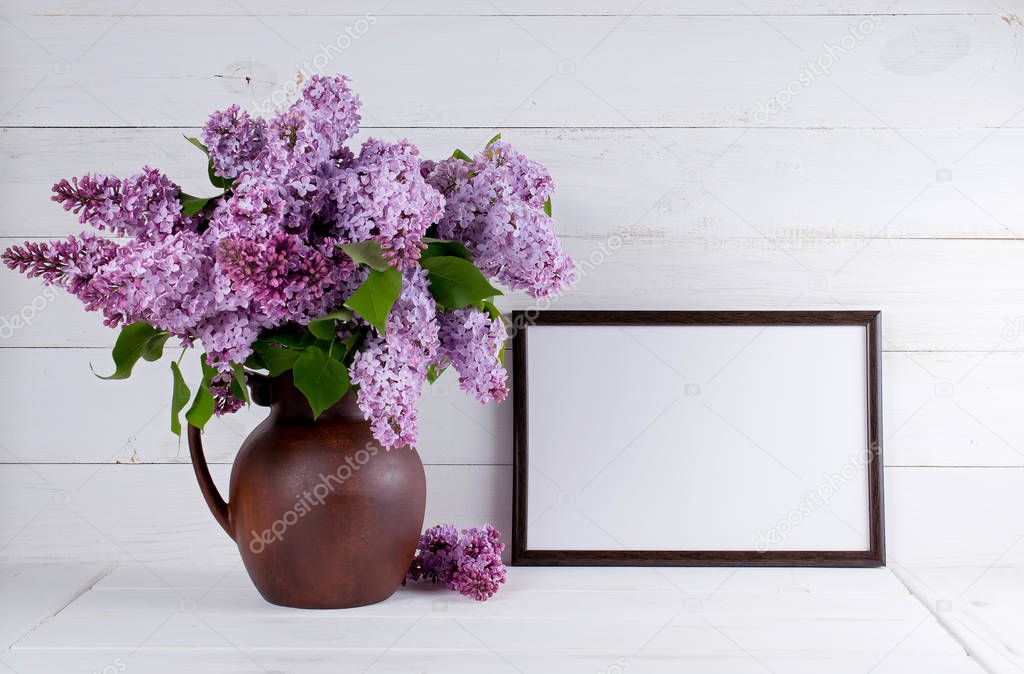 Lilac bouquet in jug with motivational frame for text