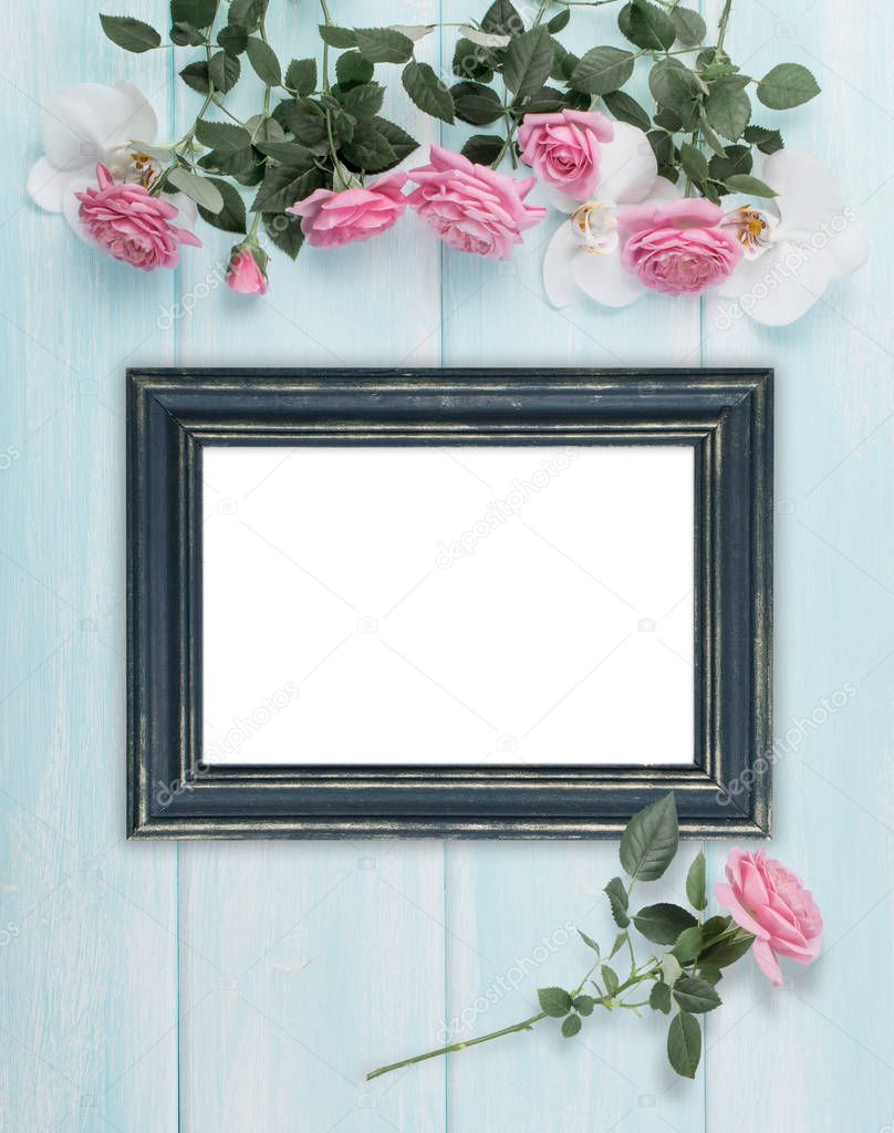 Wooden background with frames, roses and orchid flowers 