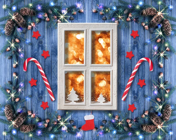 Christmas cottage window decorated with New Year decor in rustic vintage style with light illumination garland, candy cane lollipops, fir tree and spruce cones — Stock Photo, Image