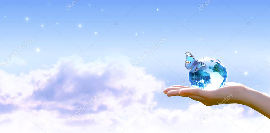 Card for World Earth Day. Clean air, Ozone Day concept. Saving environment, save and protect green planet and ecology. Earth crystal globe in human hand and butterfly on stars, blue sky background.