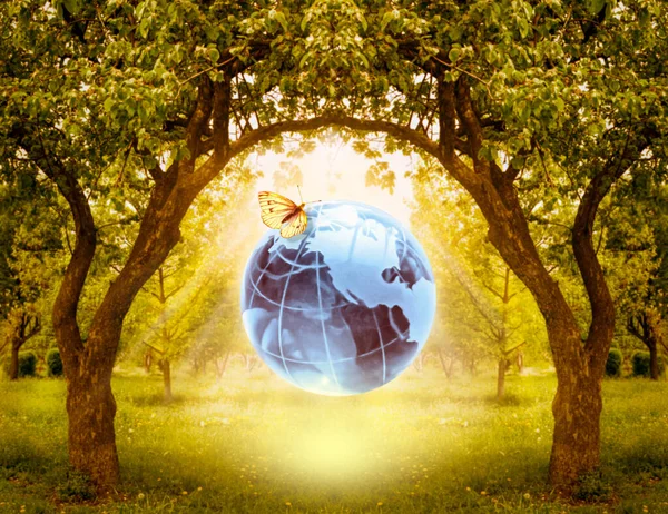Card for World Earth Day or Arbor Day. Blue glass globe ball and butterfly on blurred green trees garden background. Saving environment, save, protect clean planet and ecology, sustainable lifestyle.