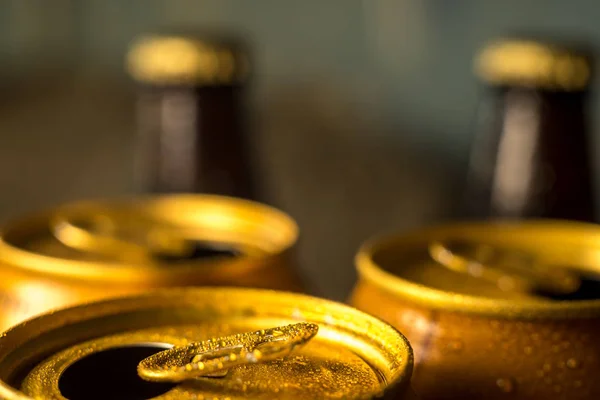 yellow beer cans closeup in cold water droplets