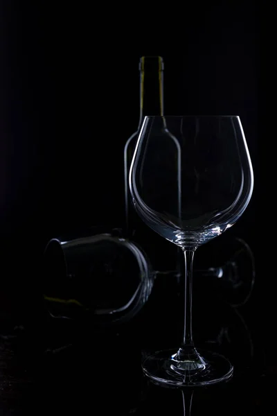 glass of red and pink wine on a black background. Wine list menu. Close up of the power of glasses and bottles in low key