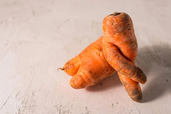 stock image ugly vegetables, carrots on a light background.funny monster carrot The concept of non-waste production in the food industry