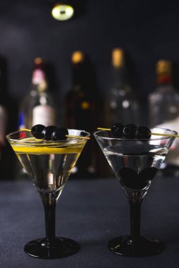 Siyah hayatlı sek martini. Martini bardağının içinde vermut kokteyli. Arkaplanda da martini bardakları. seçici odak