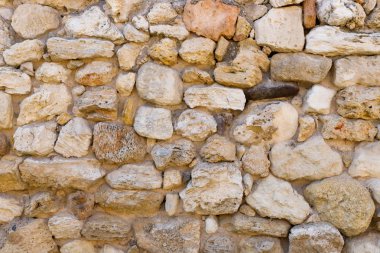 Antika taş bir duvarın dokusu. Eski kale taşından duvar dokusu. Arkaplan ya da doku olarak taş duvar.