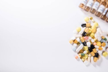 Bir sürü ilaç, hap, tablet, su toplayan paketlerdeki kapsüller, seçici odaklı makro fotoğraf. Tıbbi eczane geçmişi. Boşluğu kopyala.