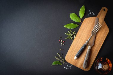 Menü için arka plan. Tahta, antika çatal bıçak, baharatlar ve zeytinyağı. Boşluğu kopyala.