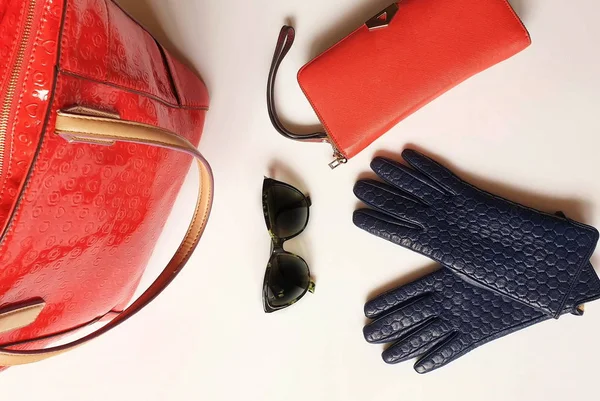 Women clothes accessories Leather gloves white jeans green black sunglasses  red purse wallet Blue White Jeans and  jumper Red Handbag girl fashion  luxury elegant concept on white background