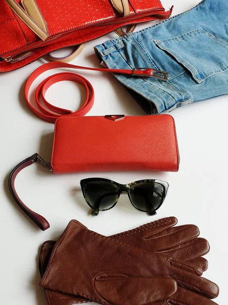 Women clothes accessories Leather gloves white jeans black sunglasses  red purse wallet Blue White Jeans and  jumper Red Handbag girl fashion  luxury elegant concept on white background stylish modern fashion