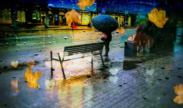 rainy evening in city autumn season  people walk  under umbrella on street lifestyle urban rainy drops  reflection on window Tallinn old town holiday in Estonia  panorama city life weather