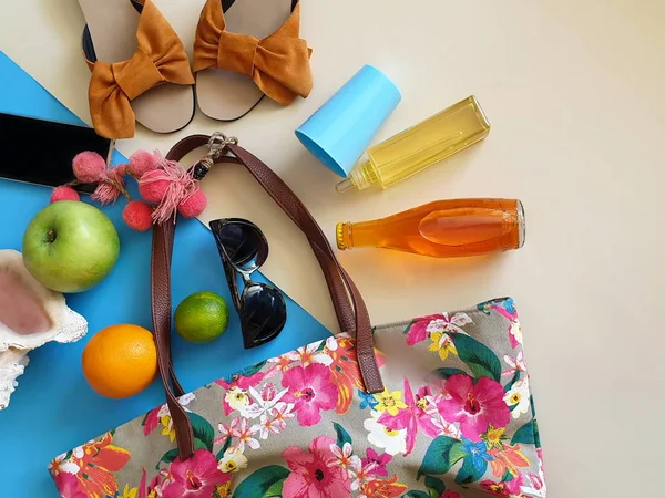 Holiday beach Women accessories Summer Girl  clothes travel background   wallet   handbag yellow sandal sunglasses   holiday  passport  travel   Phone hat   blue background copy space seashell orange juice still life blue yellow