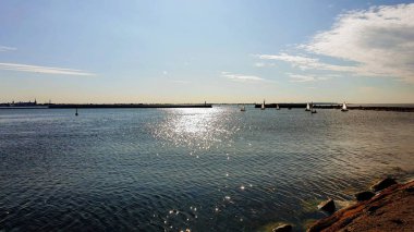  sea sunset at  bay , summer holiday romantic pink  and blue sunset at  sea beach sunlight reflection  on  water wave seashell on sand rock on horizon Tallinn shore ,travel to Europe  nature sunshine  landscape Baltic 