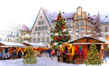 Christmas  Tallinn  marketplace In  old town square panorama   , full moon on night sky , tree light decoration , new year winter holiday in Europe blurred  light ,travel to Estonia,best  Christmas market in Europe 