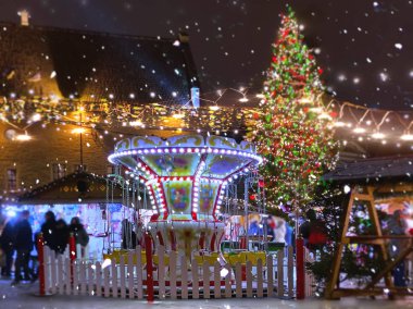 Christmas  Tallinn  marketplace In  old town square panorama   , full moon on night sky , tree light decoration , new year winter holiday in Europe blurred  light ,travel to Estonia,best  Christmas market in Europe 