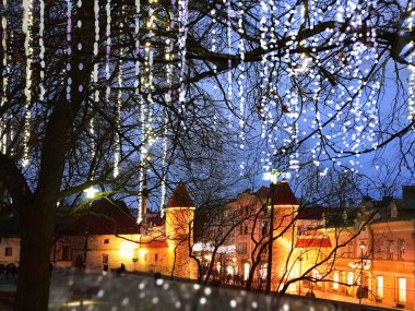 Christmas  Tallinn  marketplace In  old town square panorama   , full moon on night sky , tree light decoration , new year winter holiday in Europe blurred  light ,travel to Estonia,best  Christmas market in Europe 