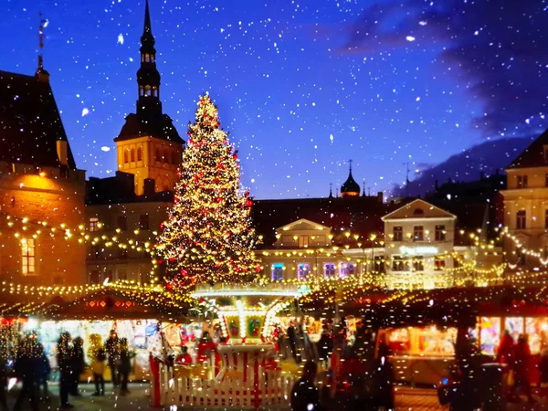 Christmas  Tallinn  marketplace In  old town square panorama   , full moon on night sky , tree light decoration , new year winter holiday in Europe blurred  light ,travel to Estonia,best  Christmas market in Europe