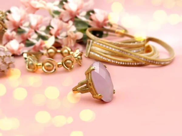 pink opal gold ring jewelry women accessories on pink floral  background