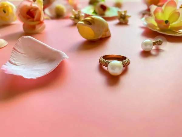Jewelry gold  white pearl Luxury Glamour fashion  costume jewelry,  rings earrings bracelet with  pink  flowers  and seashell  living coral background women accessories