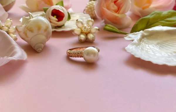 Jewelry gold  white pearl and seashell  Luxury Glamour fashion  costume jewelry with roses  flowers petal  on  pink  living coral background women accessories